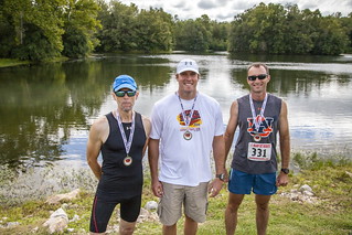 three guys with medals after the race