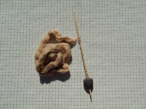 Bead spindle and brown cotton sliver