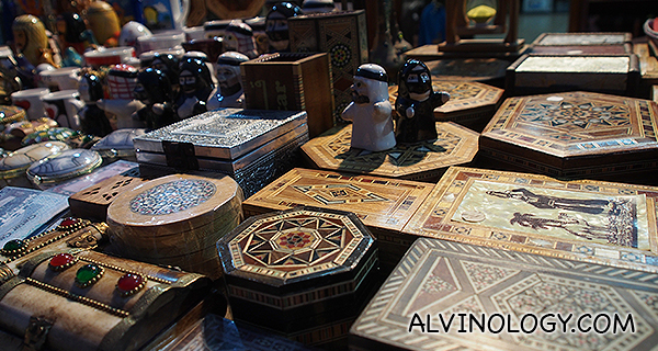 Local Qatari-shaped salt and pepper shakers on top of various ornamental boxes 