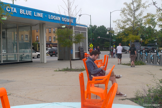 Nushu's orange chairs at the Logan Square Blue Line station