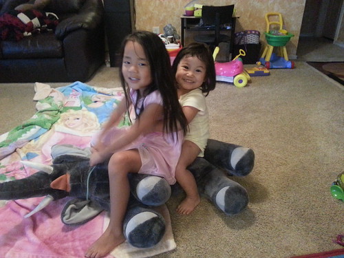 Amelie and Dani riding an elephant.