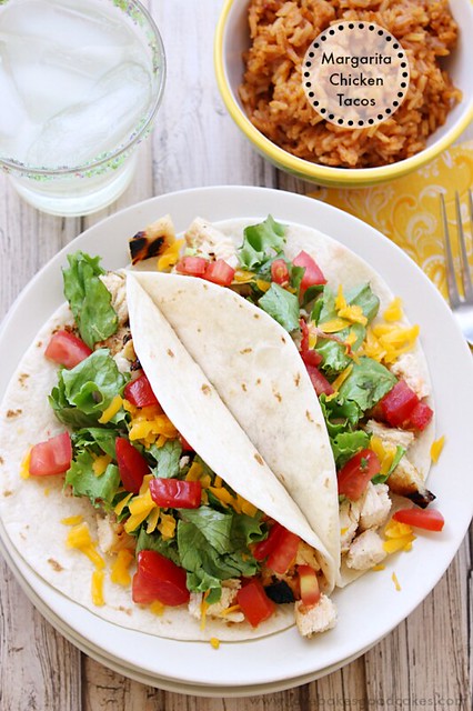Margarita Chicken Tacos open on a white plate with mexican rice.