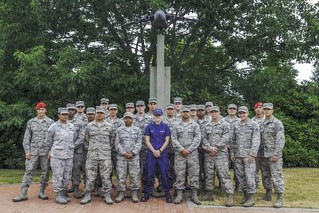 Coast Guard Petty Officer 3rd Class Whitney Jackson (middle), a maritime enforcement specialist assigned to Coast Guard Maritime Force Protection Unit Bangor in Silverdale, Wash., poses for a photo with her fellow classmates of the Julius A. Kolb Airman Leadership School class 14-E at Joint Base Lewis-McChord, Wash., July 2014. Graduating from ALS is an advancement requirement for all Air Force junior non-commissioned officers.