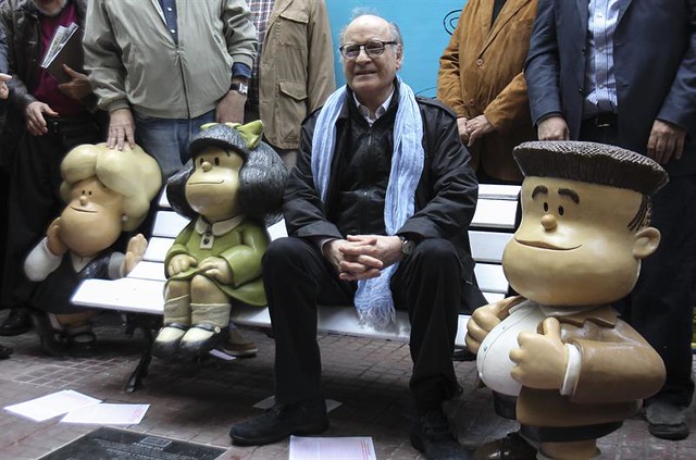 El dibujante argentino Joaquín Salvador Lavado, Quino, posa junto a una figura de su personaje Mafalda durante la presentación de dos estatuas de sus per