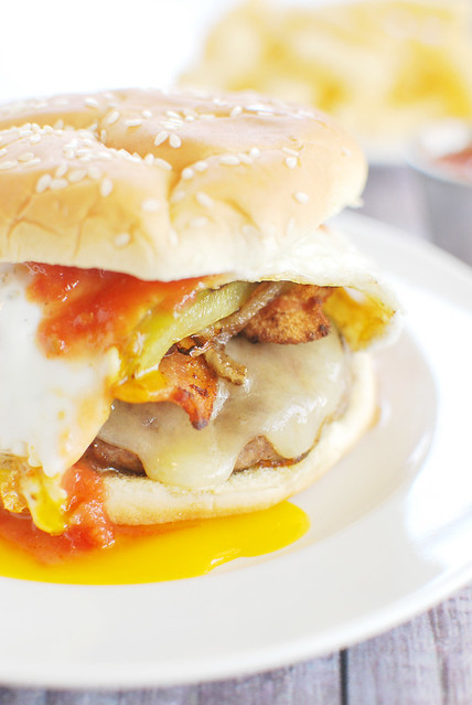 Colorado Omelet Burgers - everything you love about a Colorado Omelet as a burger. Bacon, sautéed green peppers and onions, white cheddar cheese, and a yolky egg on top. And then you pour salsa all over it.