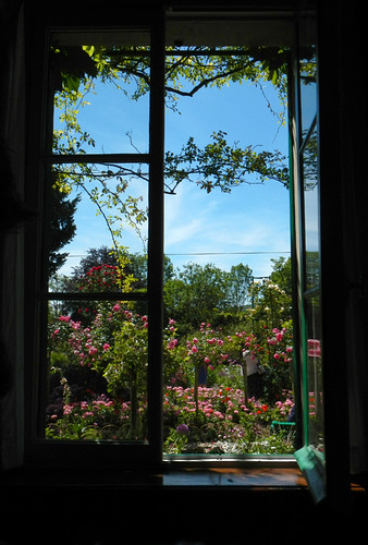A window in Monet's house overlooks his exuberant garden