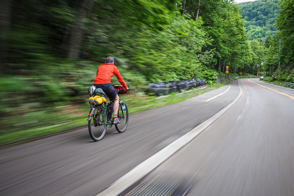 Speeding downhill on a Genesis bicycle on the Lake Shikotsu Cycling Road (Sapporo, Japan)