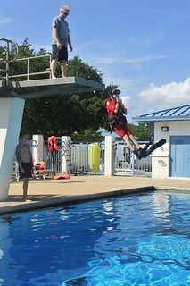 Petty Officer 3rd Class Byron Cross, a rescue swimmer at Coast Guard Air Station Clearwater, Florida, observes Kadin Parker, a recruit in the U.S. Navy Sea Cadets, as he prepares to enter the water during helicopter free fall deployment training, at the air station, Tuesday, June 6, 2014. The air station held its 4th annual Coast Guard Naval Aviation Internship, with the U.S. Navy Sea Cadets and the Pinellas Park High School First Responder Program, introducing the cadets to naval and civil aviation. U.S. Coast Guard photo by Seaman Meredith Manning