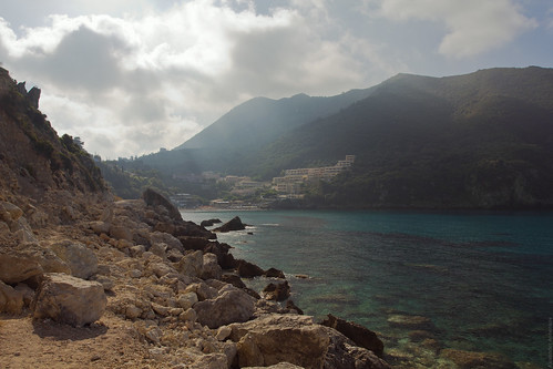 sea mountains reflection water daylight seaside rocks greece shore coastline corfu