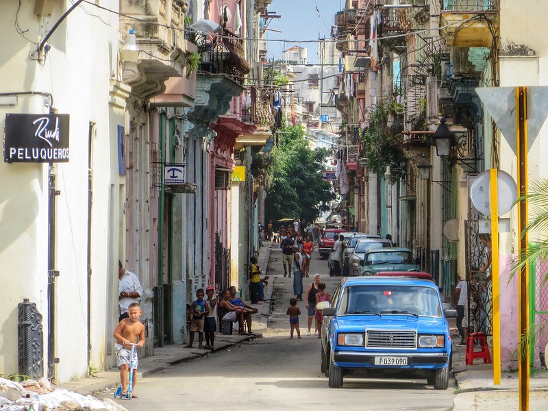 Boy on a scooter in street scene in Havana, Cuba