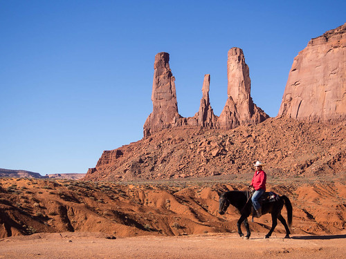 Cowboy photo op and Monument Valley's Three Sisters