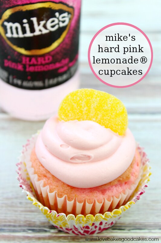 mike's hard pink lemonade® cupcake with a lemon candy on top and a bottle of Mike's behind it.