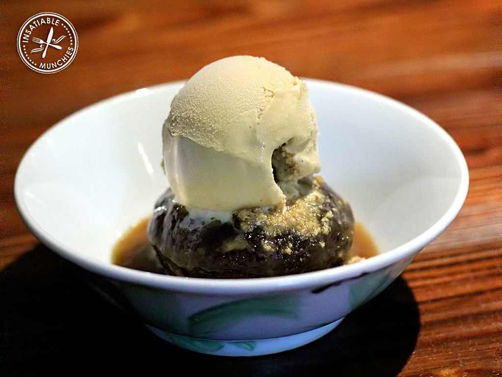Sticky Date Pudding sits in a pool of caramel and is topped with a scoop of house made salted caramel ice cream