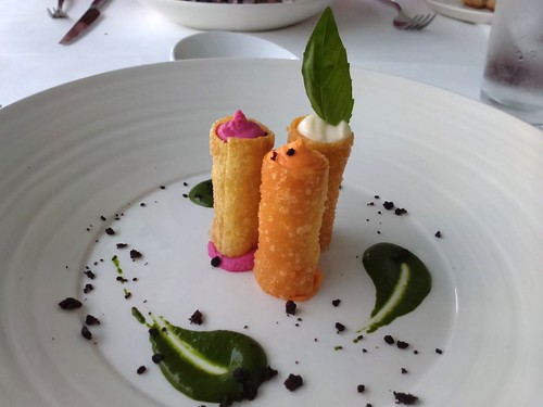 Crispy cannoli filled with burrata, beetroot, carrot, and celeriac, olive dust