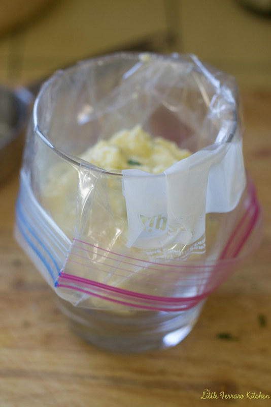 Use a resealable bag and open it up into a cup. This will help keep the filling in place. Spoon filling into the bag, making sure it's not too full. Close the bag, squeezing out as much air as you can and set aside.