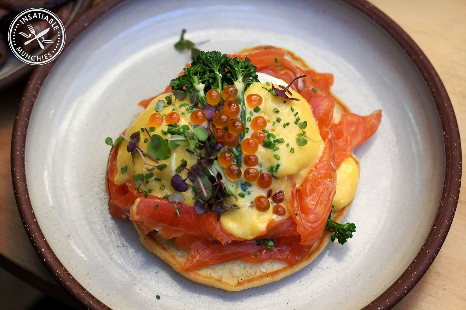 Eggs Blini: Buckwheat blini topped with poached egg, broccolini, cured salmon and sauce Mikado, a mandarin hollandaise that is a richer orange that the traditional hollandaise