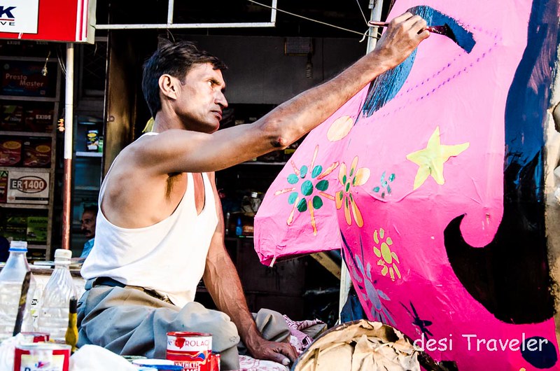 An artist gives finishing touches to a Ravana