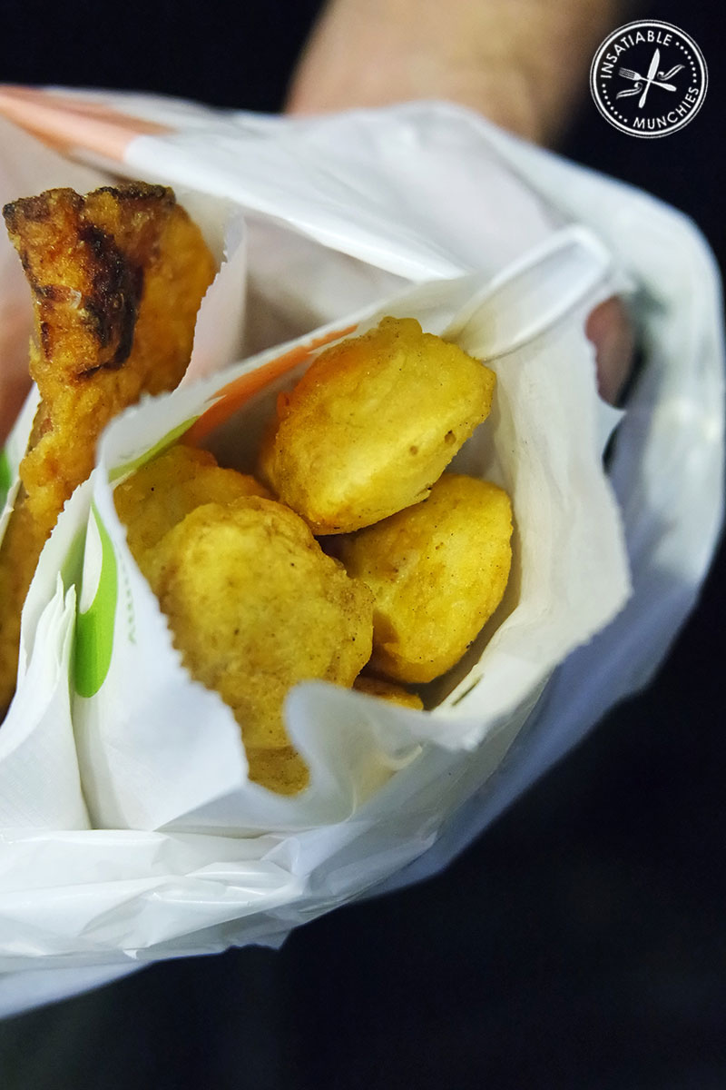 Squid balls - made from a salted squid paste - are battered, seasoned and deep fried. Served in a paper bag