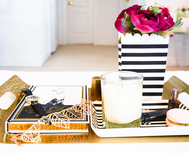 DIY HOME DECOR: use black and white striped paper bag and vase for flowers (ranunculus), with gold and glam tray from Target, white and black striped jewelry tray by J. crew, & The dress book by Megan Hess 