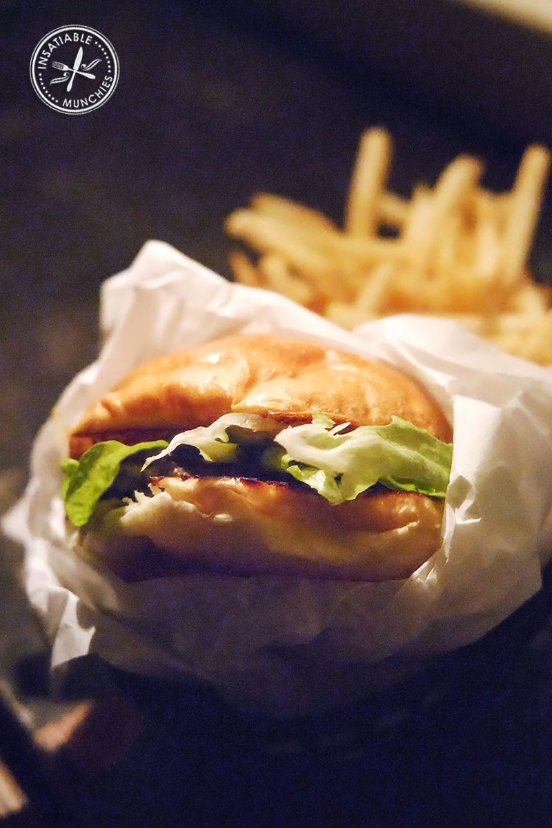 A classic Mary's Burger is served in a basket with a side of chips 