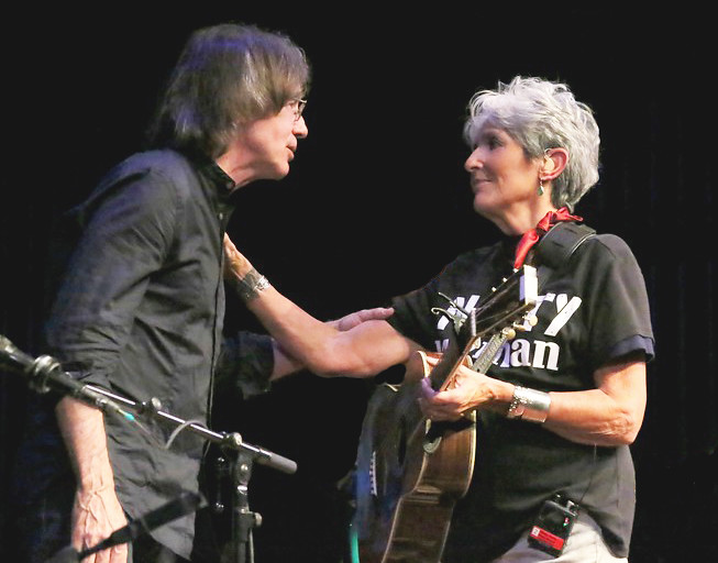 Joan Baez and Jackson Browne share a moment on stage.