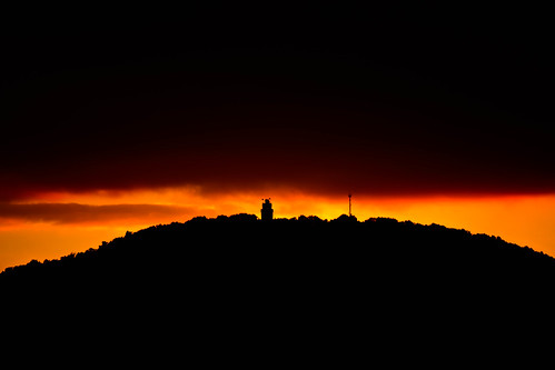 sunset tower silhouette clouds lights golden colours hill towers mount
