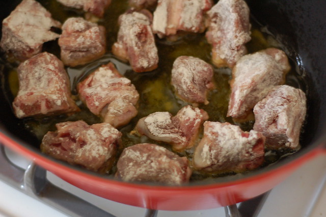 Browning the goat stew meat by Eve Fox, The Garden of Eating, copyright 2014