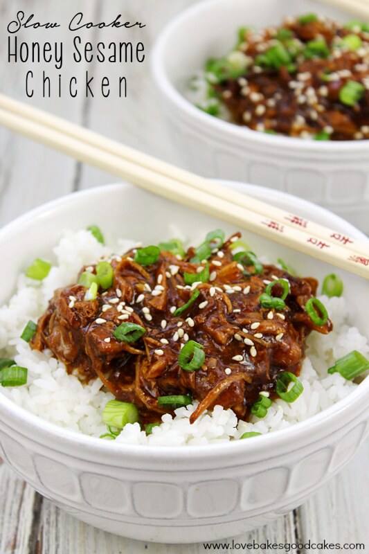 Slow Cooker Honey Sesame Chicken in two bowls with chopsticks.