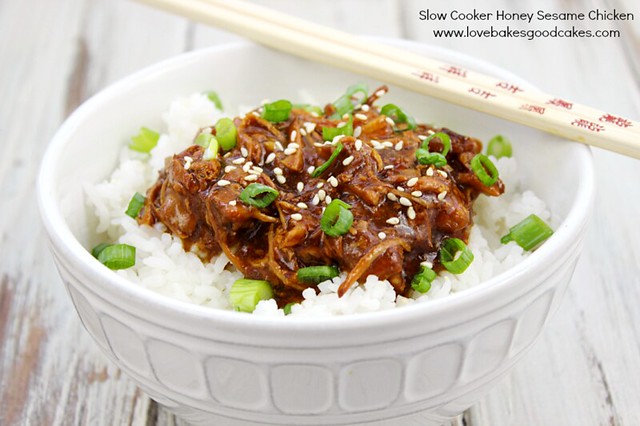 Slow Cooker Honey Sesame Chicken in a white bowl with chop sticks.