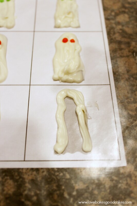 Ghost in the Graveyard Halloween Snack Pack Pudding Cup candies on parchment paper.