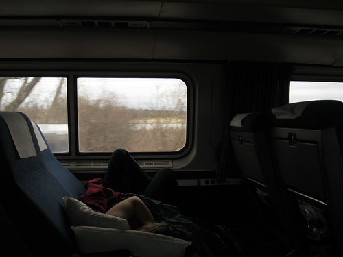 Stretching out on a train seat with pillows