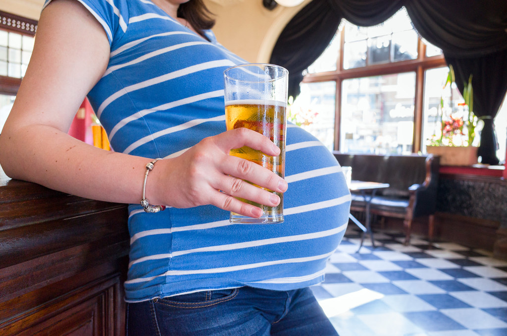 Image result for Images of a pregnant woman holding a beer
