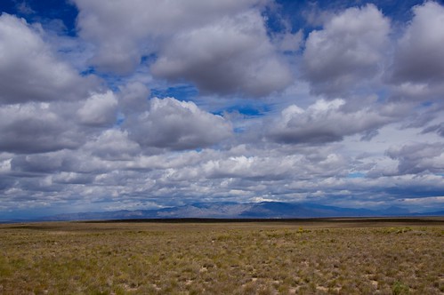 blue sky mountains west grass clouds view flat vista prairie