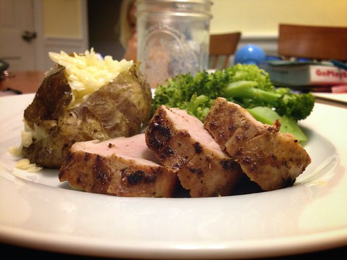 roasted pork tenderloin with steamed broccoli and a baked potato
