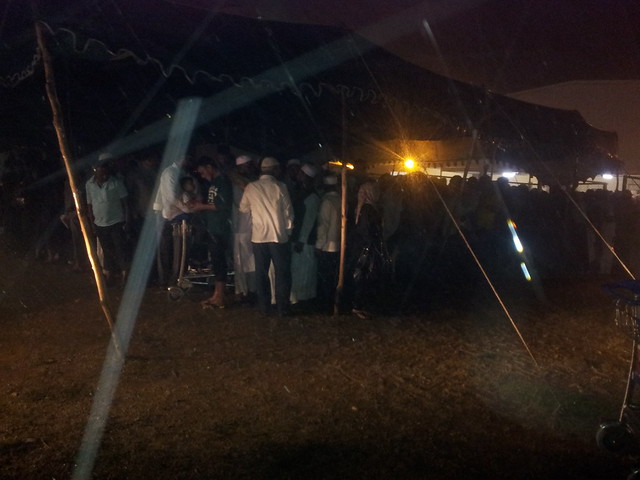 In the absence of a roof people taking shelter inside a tent.jpg