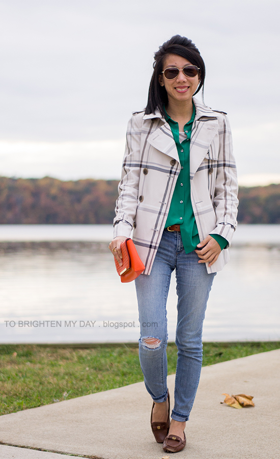 plaid patterned trench jacket, green blouse, orange clutch
