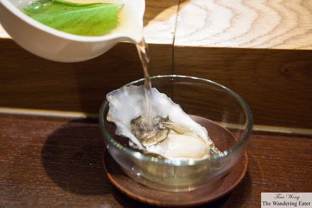 Belon oyster topped with Buddha hand broth, shiso and scallion