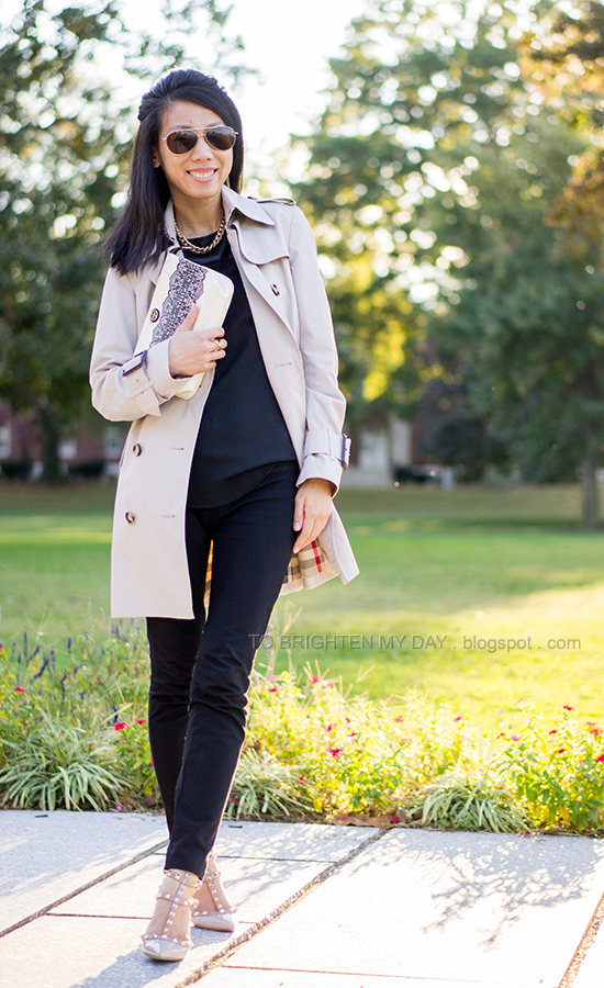 trench coat, black top + pants, lace clutch, studded heels