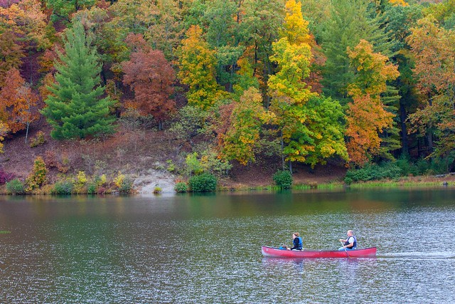 Fall colors gliding past in a canoe at Douthat State Park, Virginia